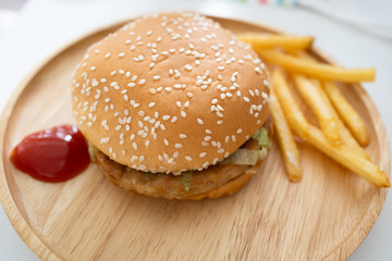Fresh hamburger on a wooden plate