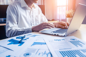 Businessman accountant or financial expert analyze business report graph and finance chart at...