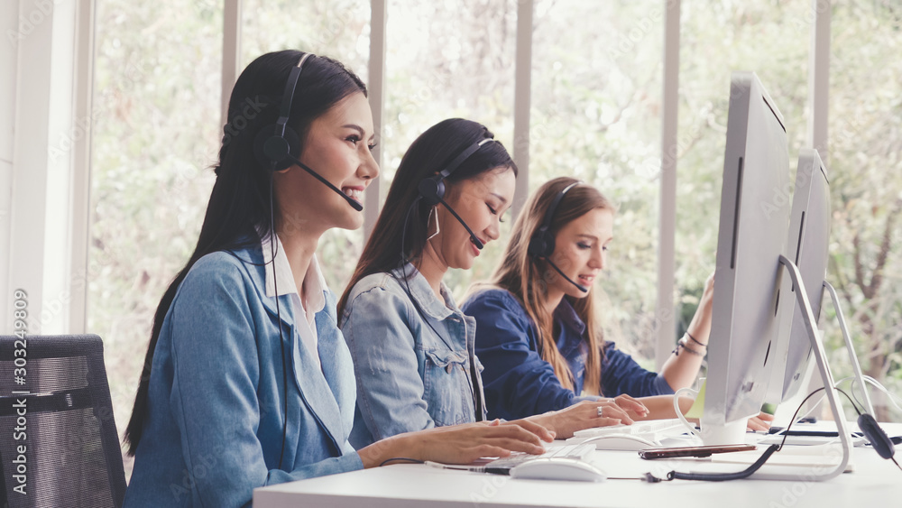 Aufkleber customer support agent or call center with headset works on desktop computer while supporting the cu