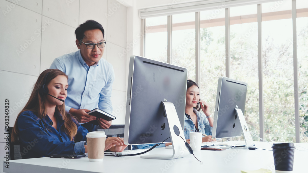 Aufkleber customer support agent or call center with headset works on desktop computer while supporting the cu