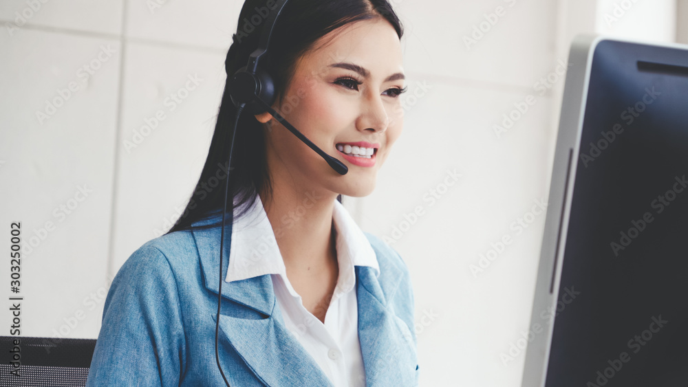 Aufkleber customer support agent or call center with headset works on desktop computer while supporting the cu
