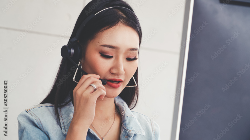 Aufkleber customer support agent or call center with headset works on desktop computer while supporting the cu