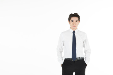 Portrait of asian man smiles, arms in pants pocket, and looks straight, isolated on white background with copy space. For motivation, finance, business, achievement, power and entrepreneur concept.