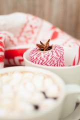 Christmas background, warm sweater, candies and spices. Winter background