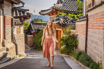 Young woman tourist in Bukchon Hanok Village is one of the famous place for Korean traditional...