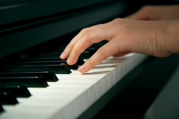 Fototapeta na wymiar Closeup female hands playing piano