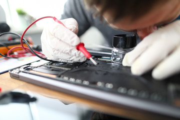 Man soldering laptop parts