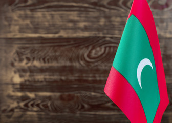 Fragment of the flag of the Republic of Maldives in the foreground blurred background copy space