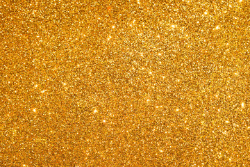 sparkles of golden glitter abstract background	