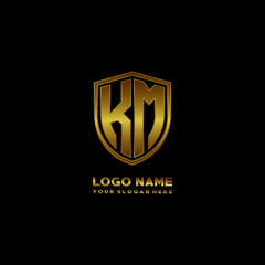 Initial letters KM shield shape gold monogram logo. Shield Secure Safe logo design inspiration