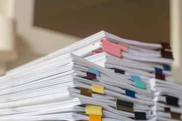 Pile of student homework that assigned to student to be completed outside class on teacher desk...