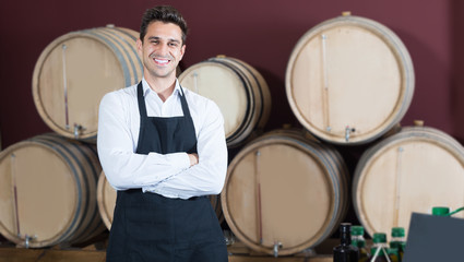Professional man seller in uniform standing in shop