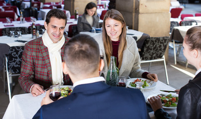 Сheerful friends at outdoor restaurant
