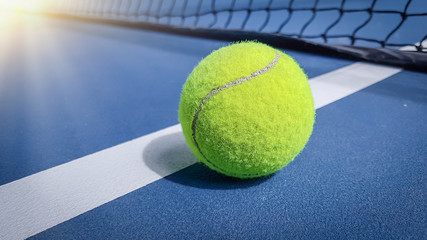 Close-up shots of tennis balls in tennis courts With a mesh as a blurred background And the light...