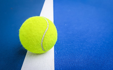 Close-up shots of tennis balls on a blue background field