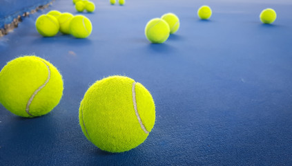 Close-up shots of tennis balls on a blue background field