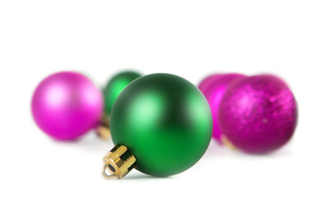 Lilac and green christmas balls on white background