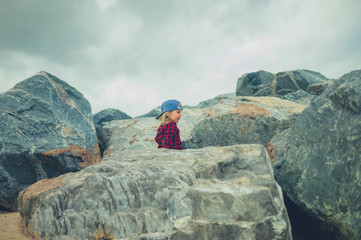 Little toddler climbing on  rocks