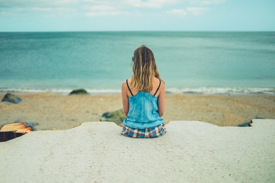 Young woman relaxing by the sea
