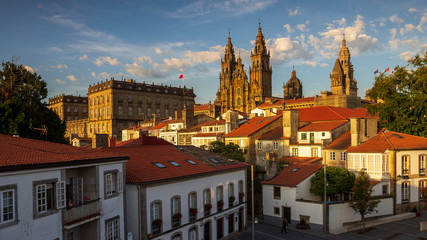Santiago de Compostela Cathedral Spectacular View with Sun Light Hitting the facade and Tiled Roofs La Coruña Galicia - obrazy, fototapety, plakaty