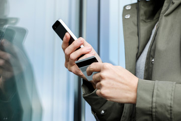 business person using mobile phone with credit card, for cashless shopping, online banking, 