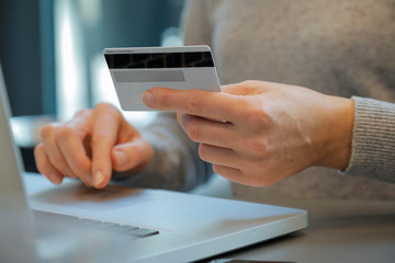 Person using laptop for online banking, online shopping cashless shopping