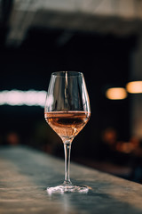 Galass with rose wine on a bar top