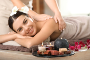 Fototapeta na wymiar Beautiful young woman relaxing in spa salon