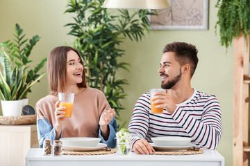 Portrait of happy young couple having dinner at home