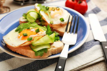 Plate with tasty sandwiches on table