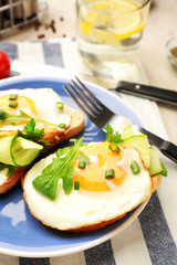 Plate with tasty sandwiches on table
