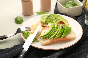 Plate with tasty sandwiches on table