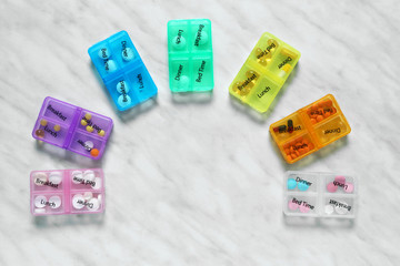 Containers with different pills on light background
