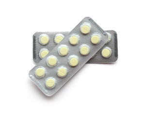 Blister packs with pills on white background