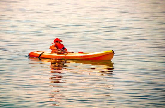 kayaking lessons. Boy with life buoy suit in kayak lessons during summer vacations in an island of Greece.