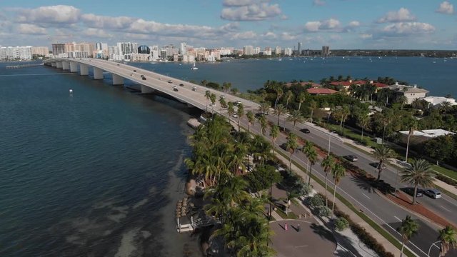 High-speed aerial backward from Bird Key in Sarasota, Florida. Great view of the John Ringling causeway and downtown Sarasota on a perfect day in South Florida