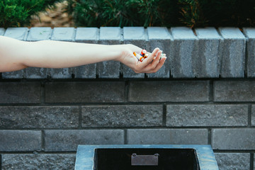 Hand above a garbage.