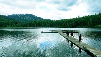 Obraz premium lake dock along overlapping mountains