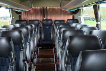 empty black seats on the bus. new black seats in the bus. The interior of a bus for tourists