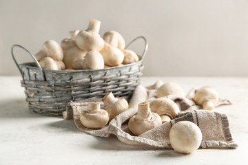 Basket with fresh mushrooms on table