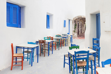 Traditional greek street with cafe tables in Amorgos island, Cyclades, Greece