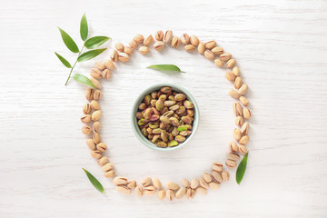 Fototapeta na wymiar Composition with tasty pistachio nuts on table
