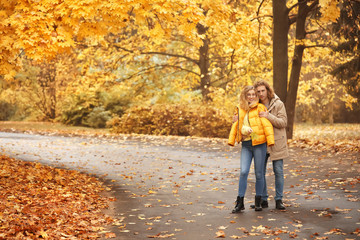 Fototapeta premium Young couple in park on autumn day