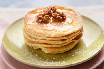 Plate with tasty sweet pancakes on table, closeup