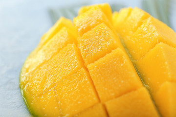 Ripe cut mango on table, closeup view