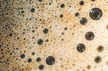 Air bubble foam formed on freshly flavored black coffee.
