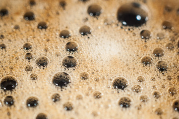Air bubble foam formed on freshly flavored black coffee.