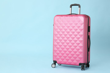 Packed suitcase on color background. Travel concept