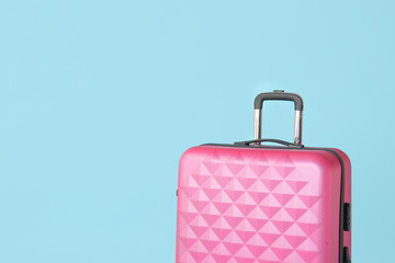 Packed suitcase on color background. Travel concept