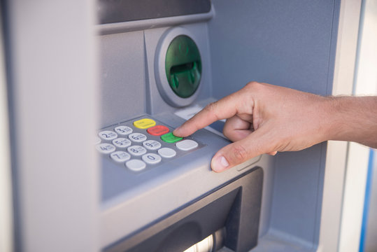 Hand Entering Personal Identification Number On ATM Dial Panel